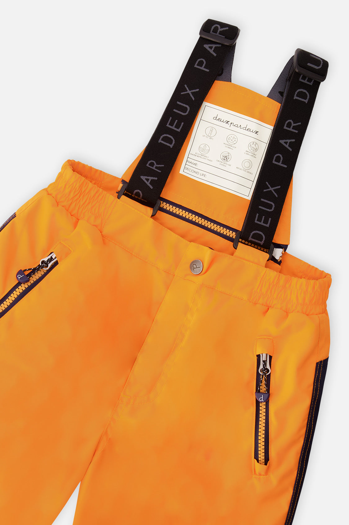 Close-up of the orange snow pants zippered pocket and suspenders