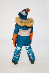 Child in the colorblock PLAY jacket and blue bear-print snow pants, third lookbook shot