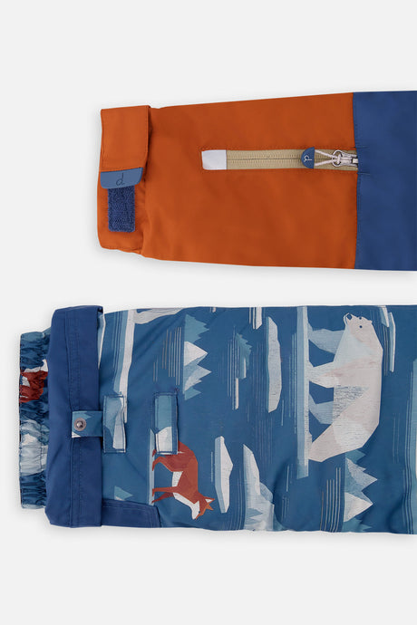 Close-up of the rust sleeve ski-pass pocket and the adjustable polar bear-print pant hem
