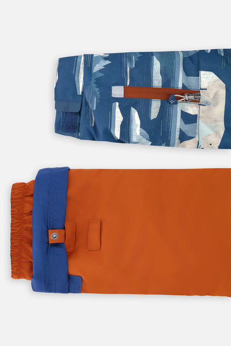 Close-up of the polar bear-print sleeve ski-pass pocket and the adjustable rust pant hem