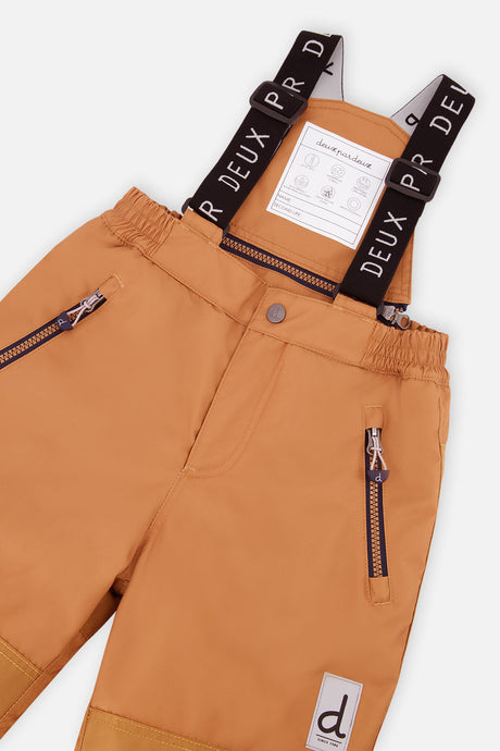 Close-up of the brown snow pants waist, suspenders and zippered pockets