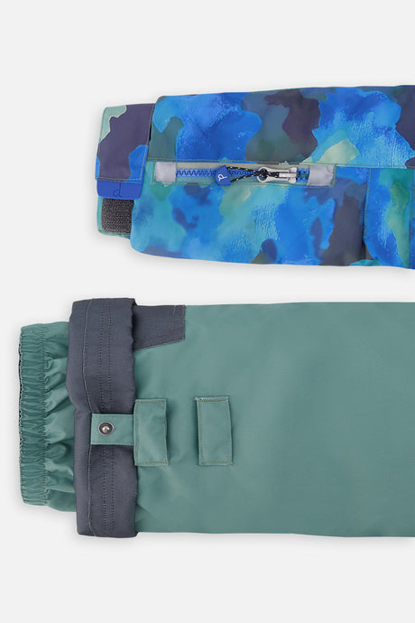 Close-up of the camouflage PLAY jacket ski-pass sleeve pocket and green pant hem