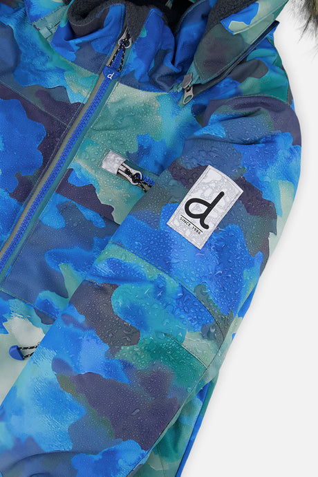 Close-up of the Deux par Deux blue camouflage PLAY jacket shell and sleeve logo patch