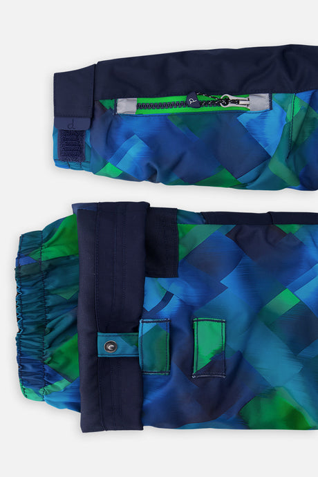 Close-up of the checkered PLAY jacket ski-pass sleeve pocket and the adjustable pant hem