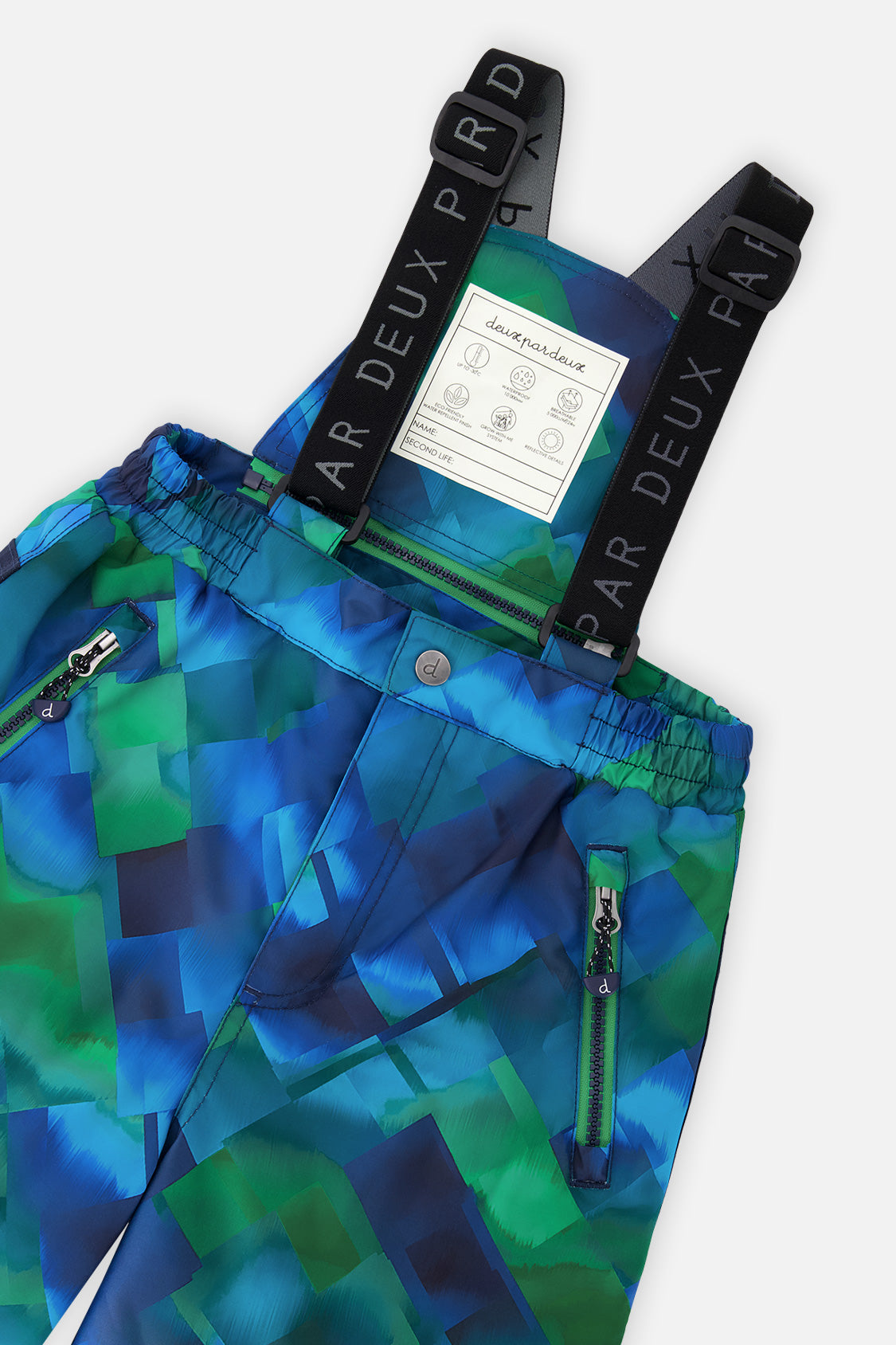 Close-up of the Deux par Deux checkered PLAY snow pants waist, zippered pockets and suspenders