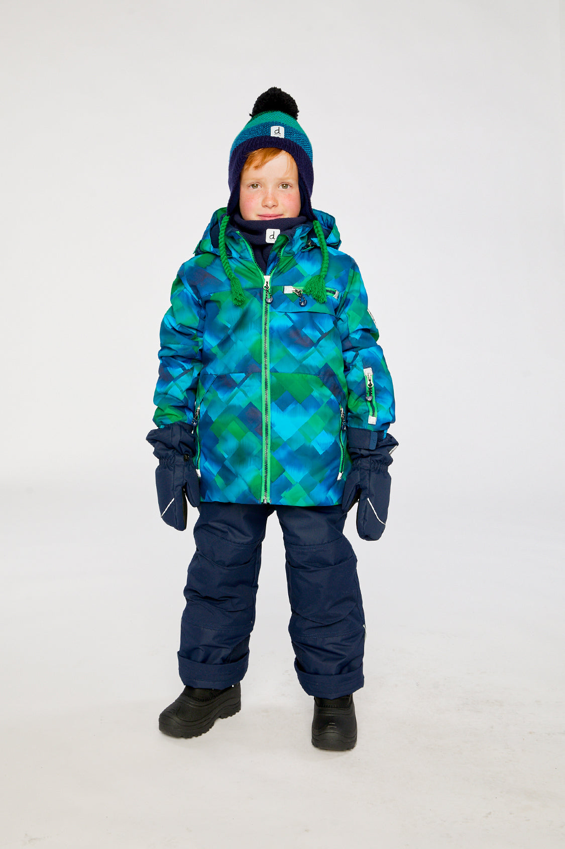 Child wearing the blue and green checkered Deux par Deux PLAY snowsuit, lookbook view 4