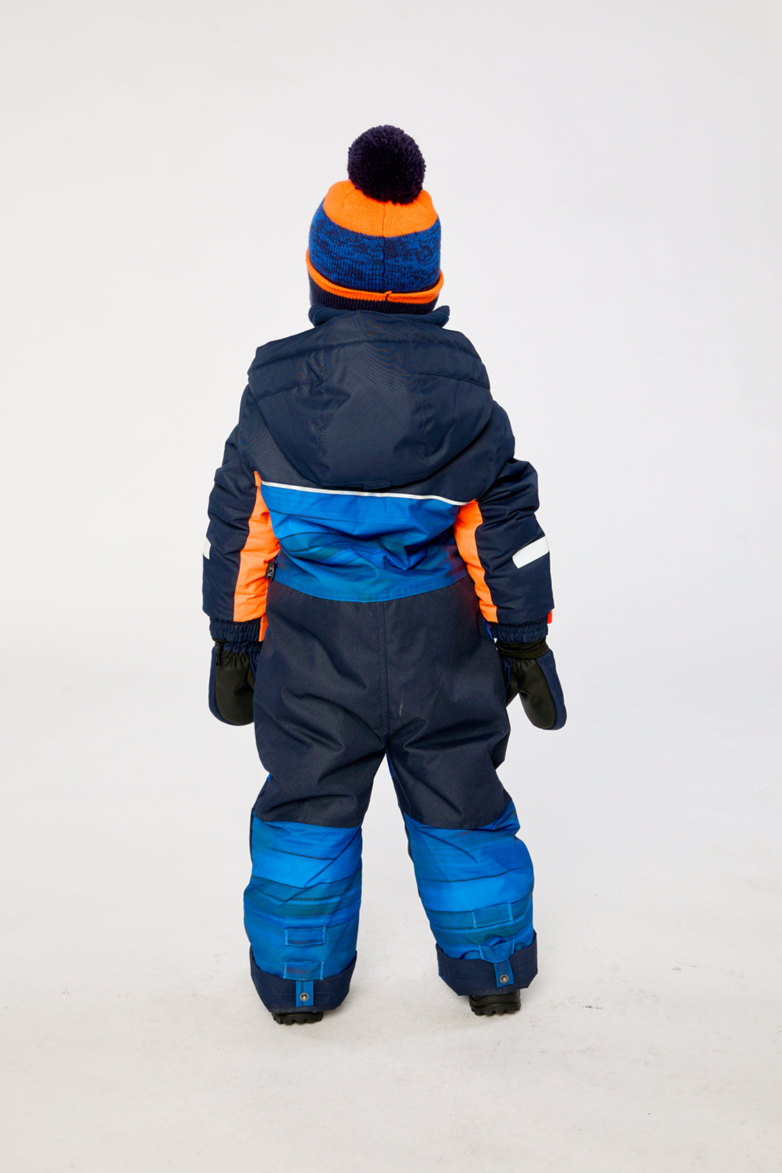 Child wearing the Deux par Deux striped PLAY one-piece snowsuit, back view