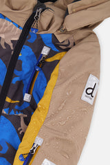 Close-up of the Deux par Deux dinosaur print PLAY snowsuit shell, zipper and sleeve logo patch