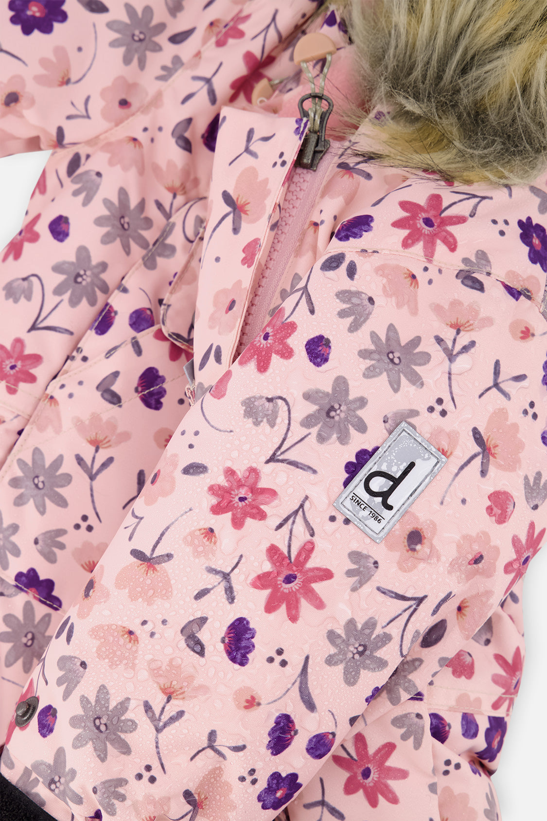 Close-up of the pink mini flower print fabric with front zipper and Deux par Deux logo