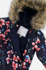 Close-up of the faux-fur trimmed hood and fleece-lined chest of the navy blue floral print snowsuit