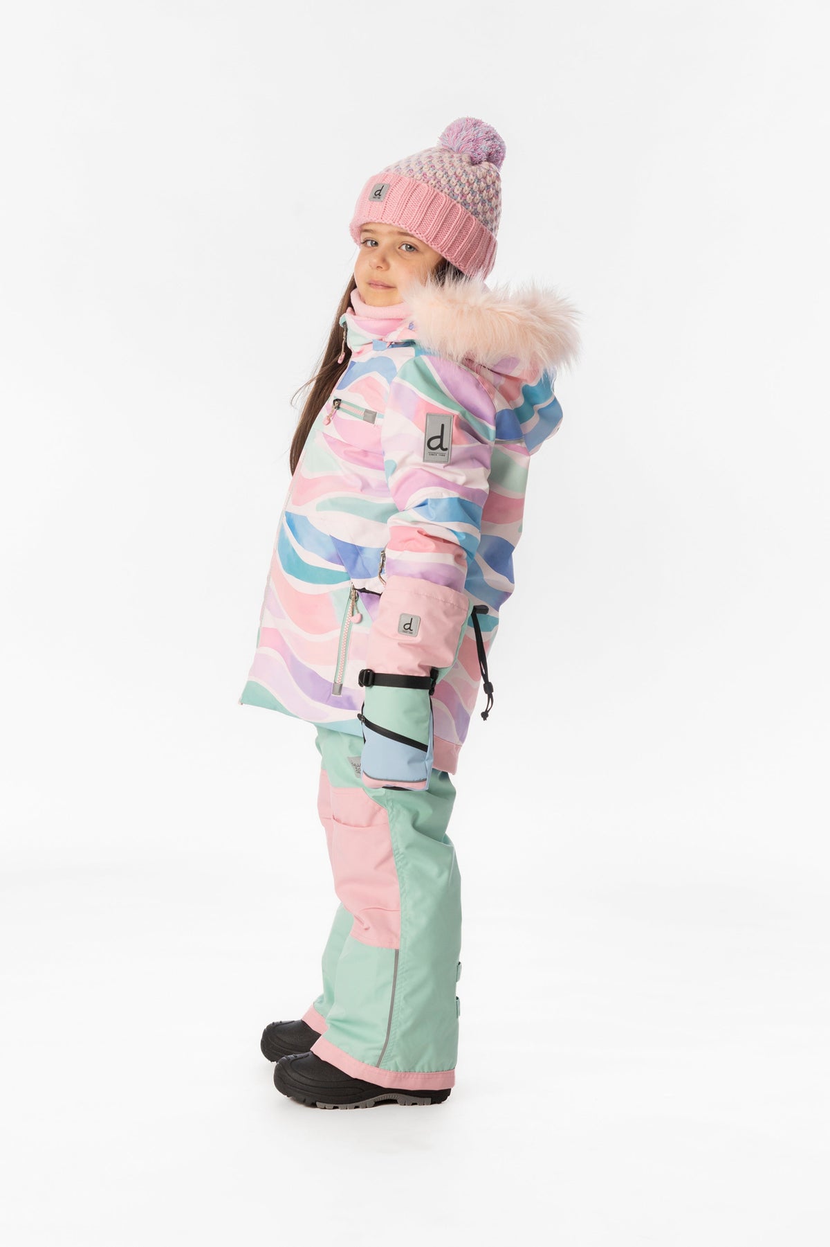 Child wearing the multicolor line print Deux par Deux PLAY snowsuit, side view