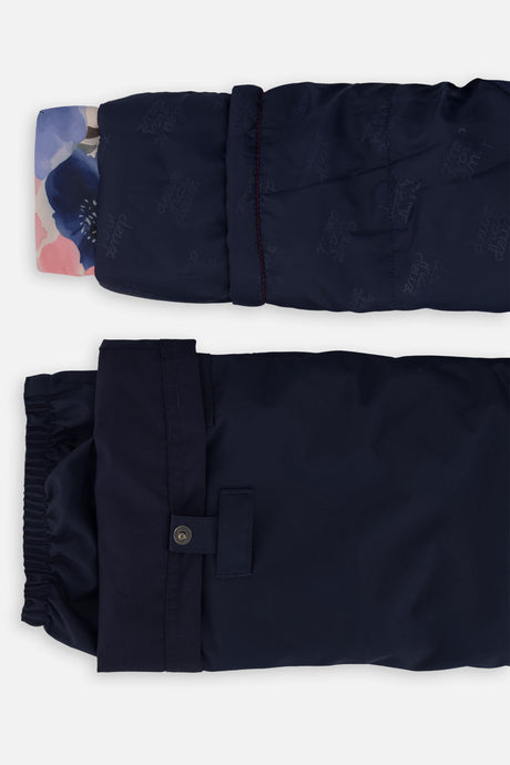 Close-up of the PLAY jacket cuff and the adjustable snow pant hem with snap tab
