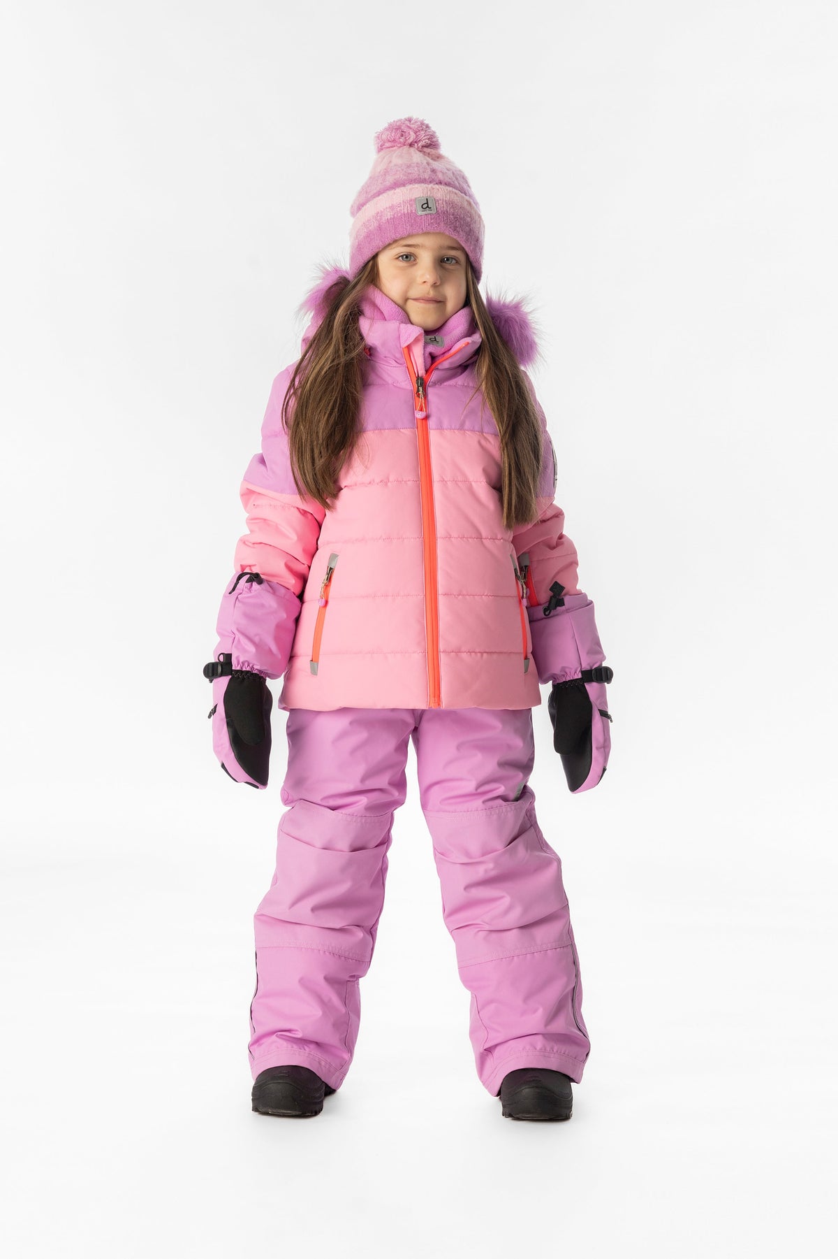 Girl standing in the pinkish violet and pink Deux par Deux PLAY snowsuit, full-length front view