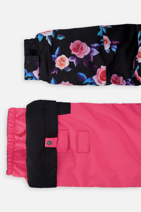 Close-up of the rose-print PLAY jacket cuff and the adjustable pink pant hem