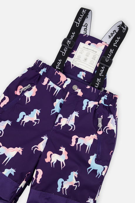 Close-up of the purple unicorn PLAY snow pants waist, zip pocket and logo suspenders