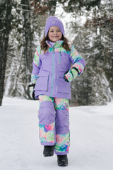 Child in the Deux par Deux PLAY snowsuit with diamond-print pants, second lifestyle view