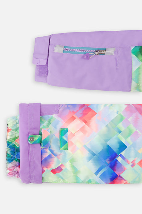 Close-up of the lavender sleeve ski-pass pocket and the adjustable diamond-print pant hem