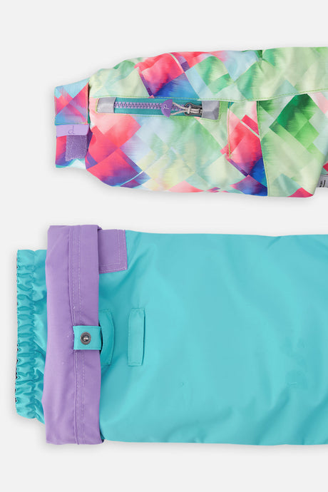 Close-up of the diamond-print sleeve ski-pass pocket and the adjustable turquoise pant hem