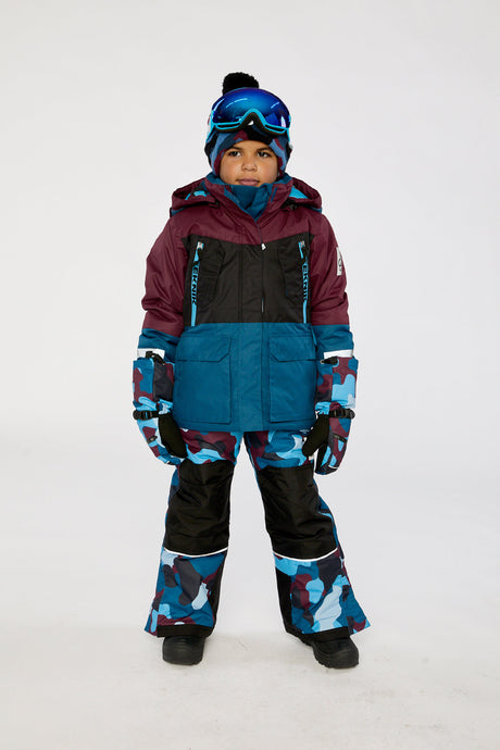 Deux par Deux boys' TEKNIK two-piece snowsuit in blue and red camouflage – worn by a model