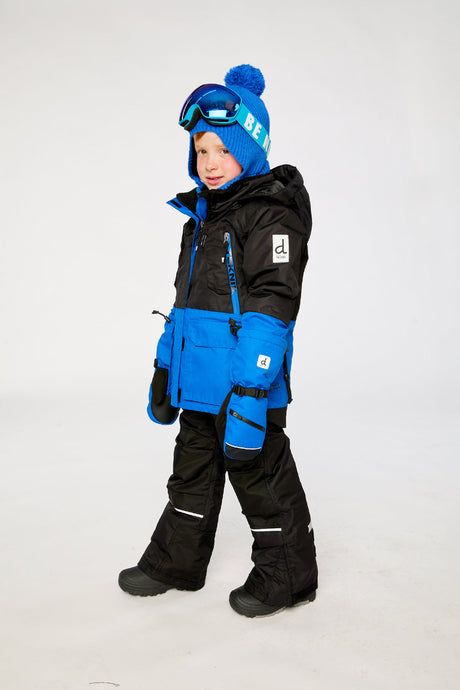 Deux par Deux boys' Teknik two-piece snowsuit in black and royal blue – on a child model, side view