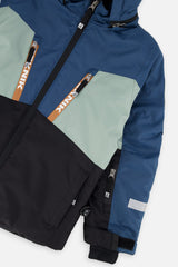 Close-up of the chest zip pockets and sleeve on the navy and pale green TEKNIK jacket