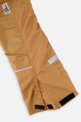 Close-up of the tan snow pants leg with reflective strip and reinforced panel