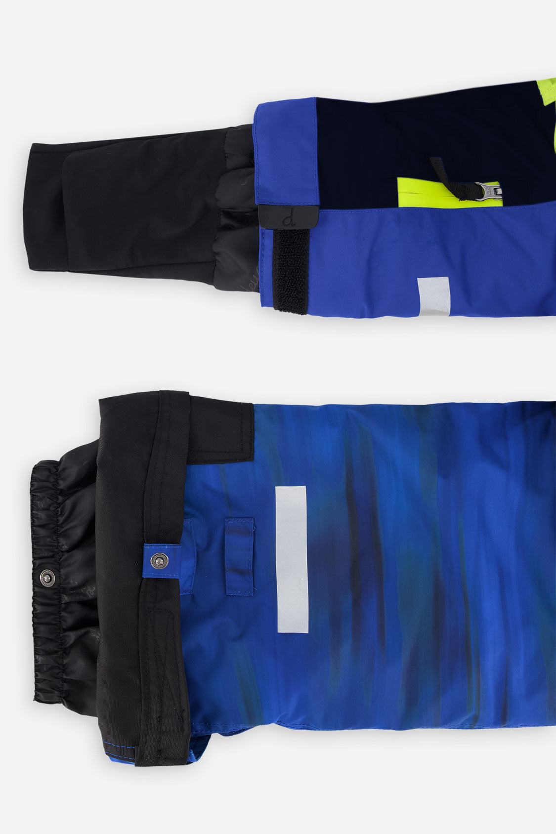 Close-up of the TEKNIK jacket cuff and the adjustable snow pant hem with snap tab