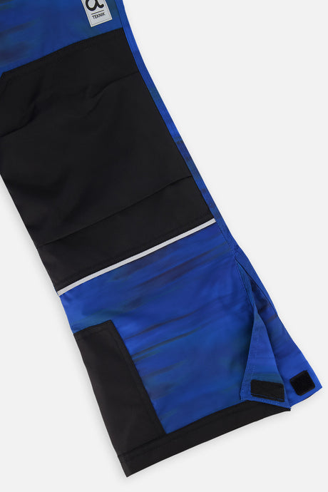 Close-up of the blue printed snow pants leg with black reinforced knee