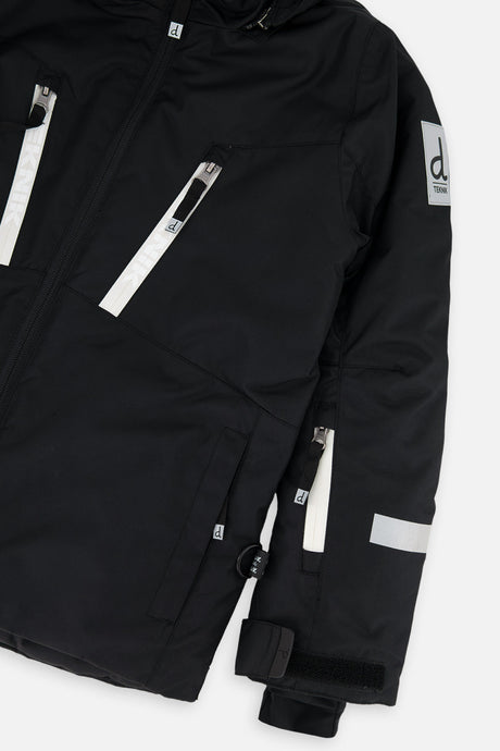 Close-up of the chest zip pockets and sleeve on the black TEKNIK jacket