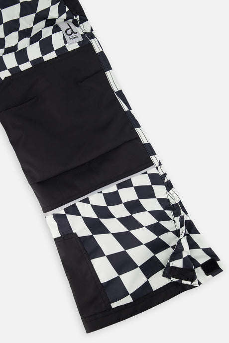 Close-up of the black reinforced knee and hem on the checkered snow pants