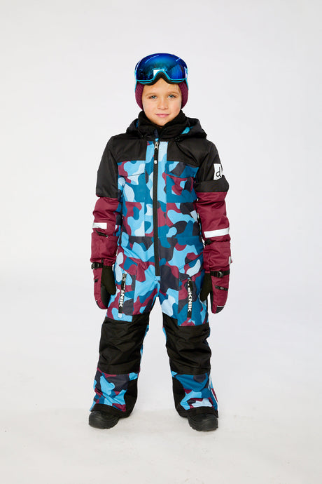 Deux par Deux boys' Teknik one-piece snowsuit in blue and red camouflage – worn by a child model, full length