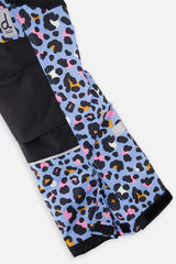 Close-up of the blue leopard print snow pants leg with reinforced panels and inner snow gaiter
