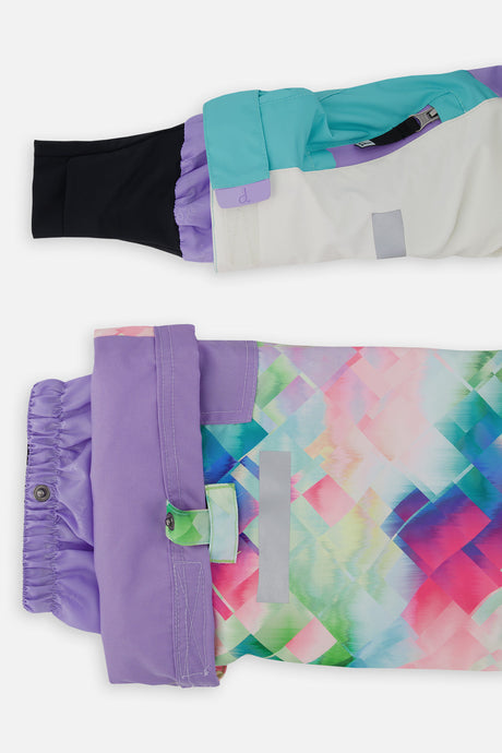Close-up of the TEKNIK jacket cuff and the adjustable snow pant hem with snap tab