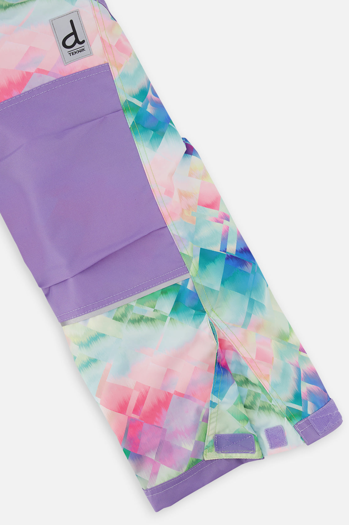 Close-up of the diamond print snow pants leg with reinforced panels and inner snow gaiter