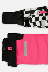 Close-up of the TEKNIK jacket cuff and the bright pink snow pant hem with snap tab