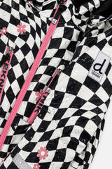 Water beading on the checkered TEKNIK jacket beside the pink zipper and logo patch