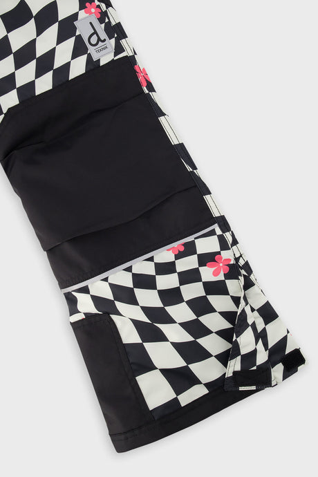 Close-up of the matching checkered snow pants leg with reinforced panels and inner snow gaiter