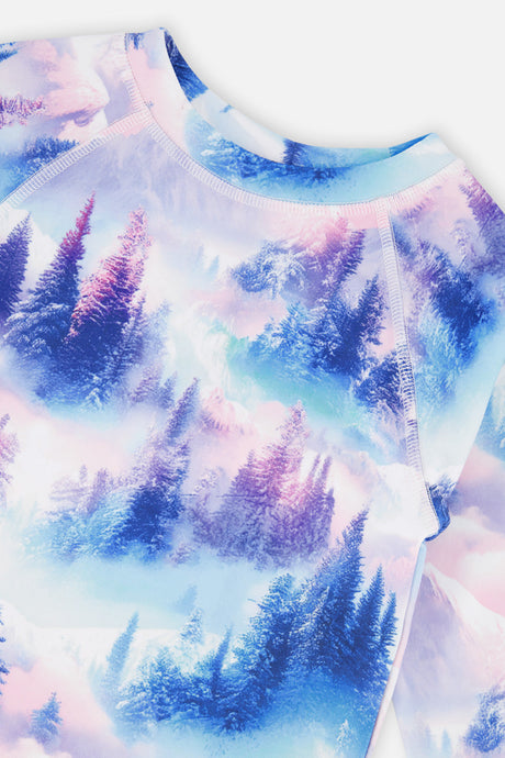 Close-up of the misty pine tree and mountain print and crew neckline on the thermal top