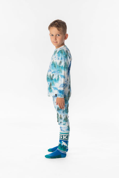 Child wearing the blue mountain print thermal base layer set, side view