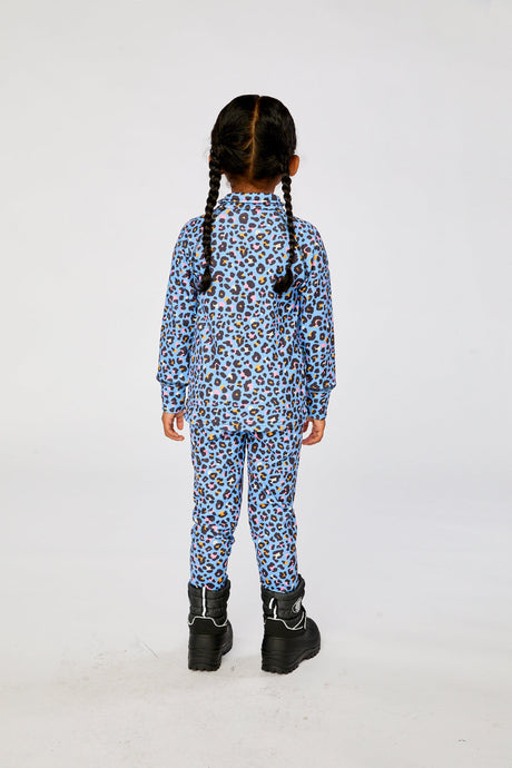 Child wearing the blue leopard print Deux par Deux thermal underwear set with black boots, back view