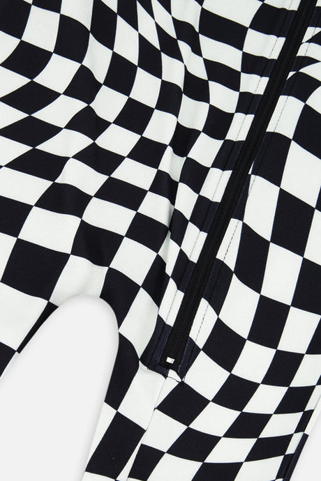 Close-up of the front zipper and wavy checkered print on the black and white Deux par Deux one piece thermal underwear