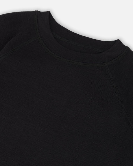 Close-up of the black crew neckline and raglan sleeve seam on the Deux par Deux merino blend thermal top