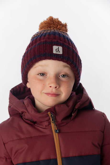 Child wearing the Deux par Deux burgundy and brown jacquard pompom toque