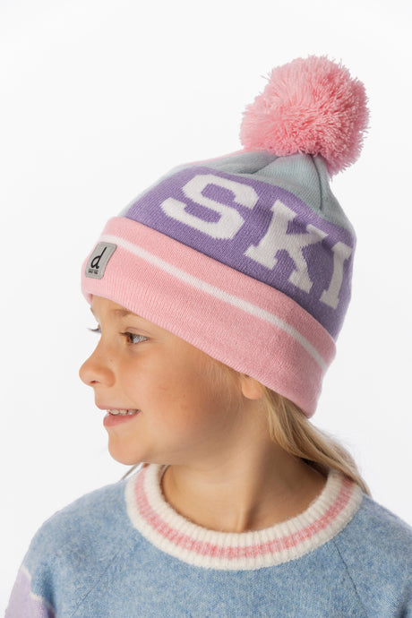 Girl wearing the light blue and pink SKI band toque with a blue knit sweater, side view