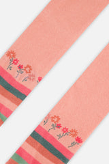 Close-up of the flower row and peach-pink and green stripes on the knit tights