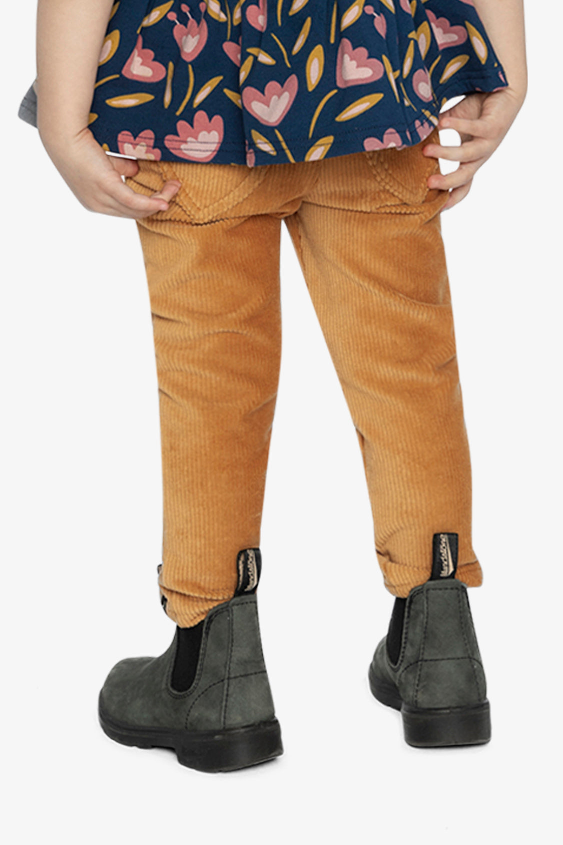Child wearing the mustard treggings with gray boots, back view