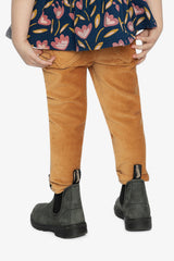 Child wearing the mustard treggings with gray boots, back view