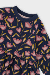Close-up of the ribbed collar and the pink tulips on the deep blue Deux par Deux peplum top