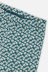 Close-up of the white daisy print and waistband on the Deux par Deux teal leggings