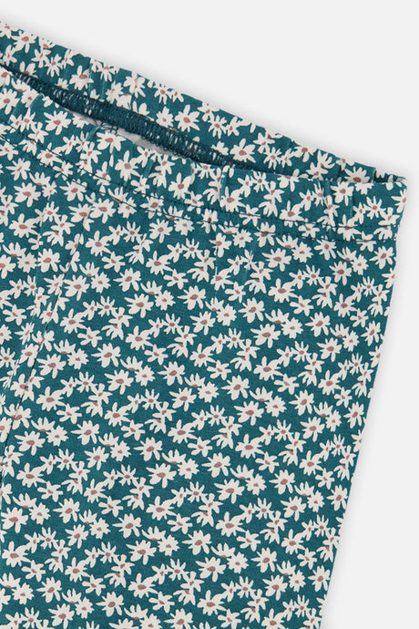Close-up of the white daisy print and waistband on the Deux par Deux teal leggings